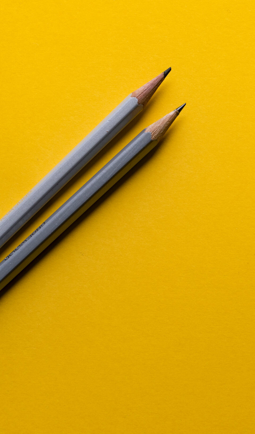 Grey Pencils on a yellow background, by Joanna Kosinska on Unsplash